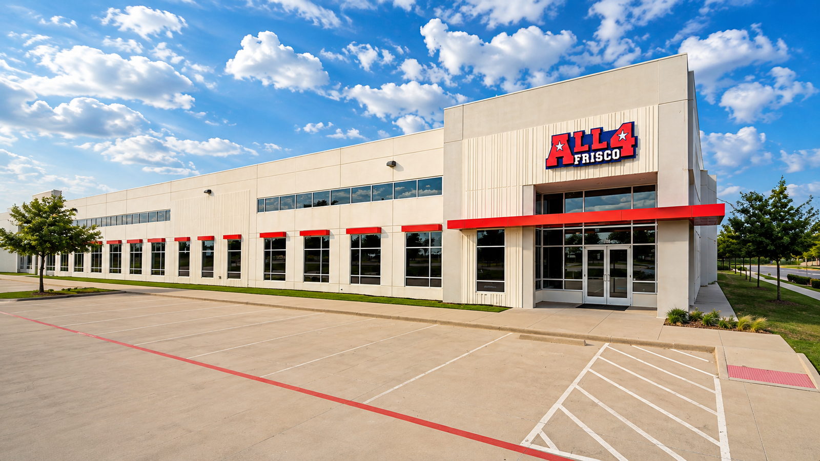 The All 4 Frisco building, a cream tilt-wall facility with red window awnings and the All 4 Frisco sign above the entrance.